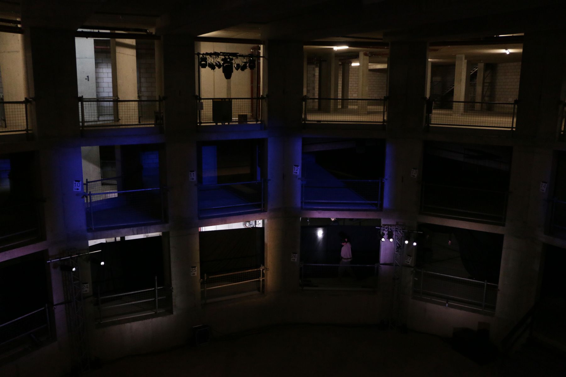 Empty tiered venue lit in blue before doors