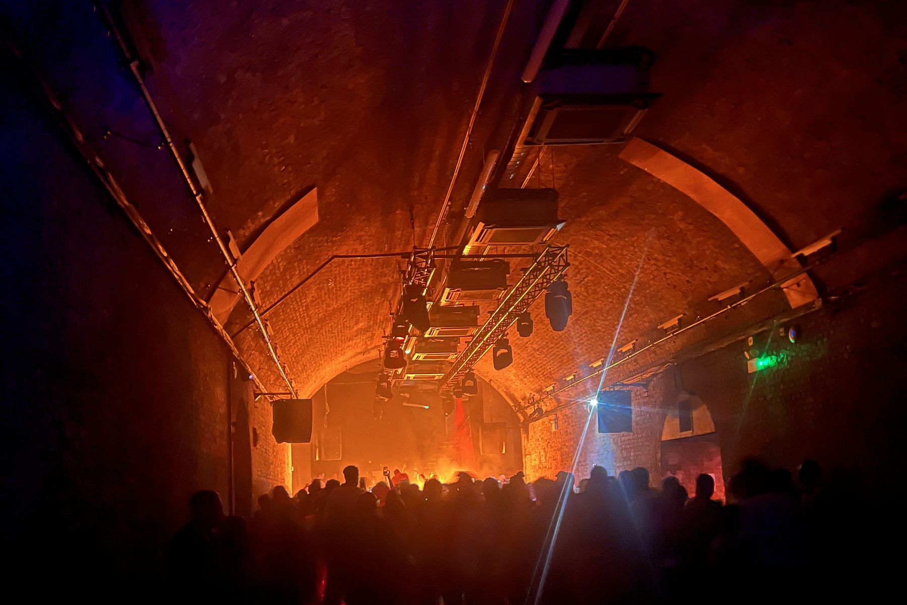 Rig hung under the arches of a warm-lit venue